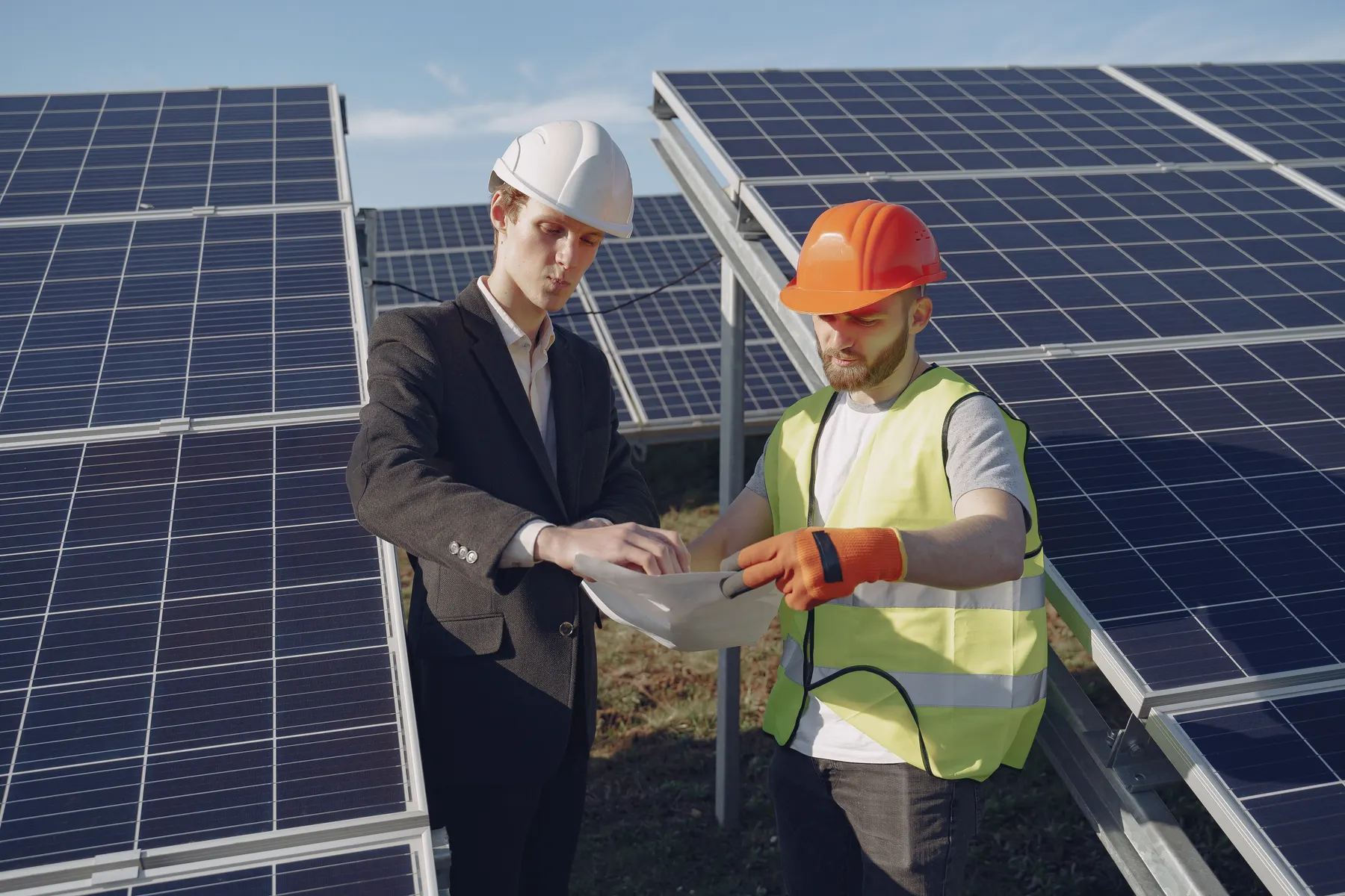 Engineers reviewing technical documents at a solar-energy installation